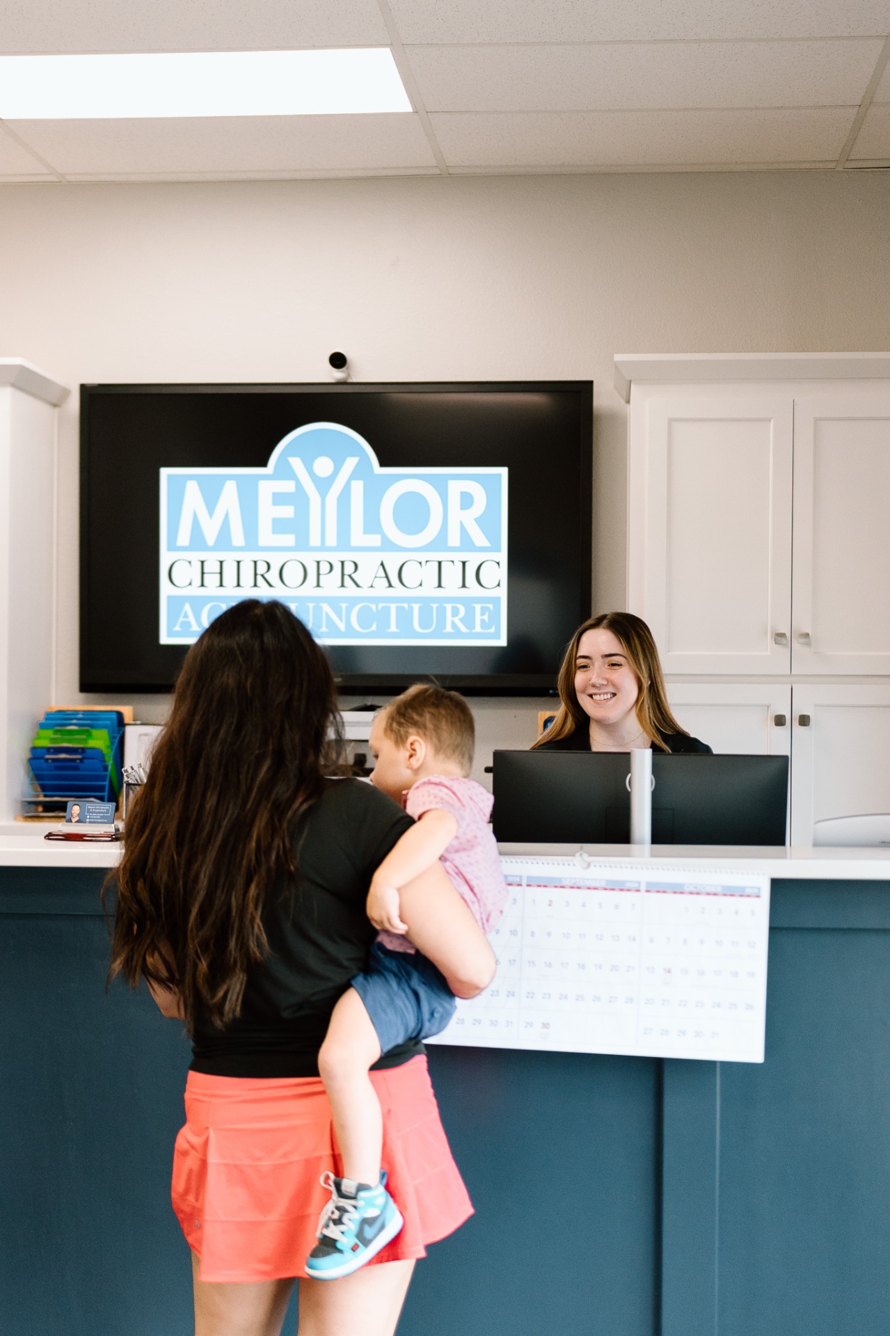 Lenexa chiropractor Dr. Meylor consulting with patient at Meylor Chiropractic office reception